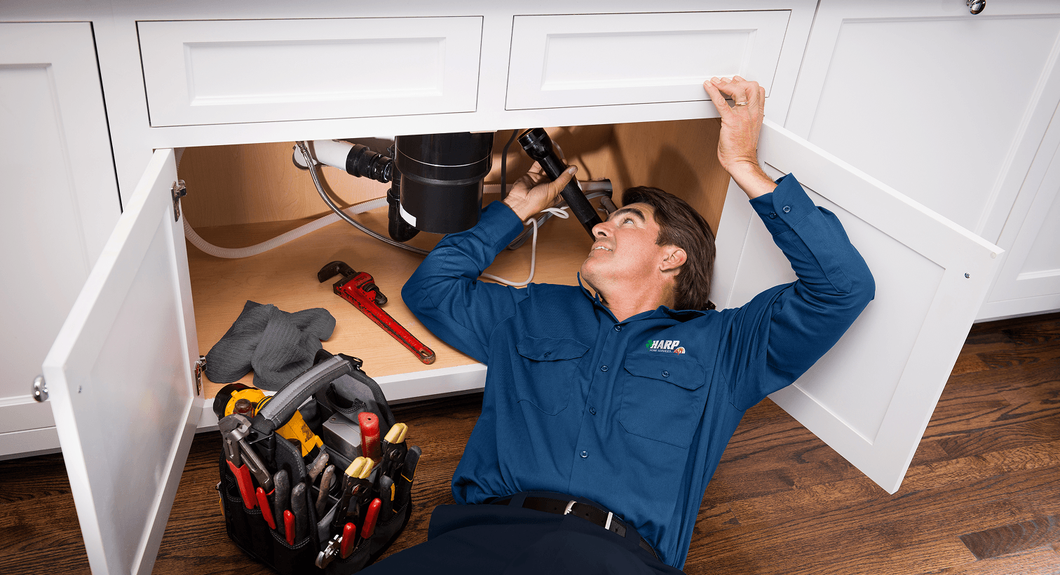 Tech inspecting under sink