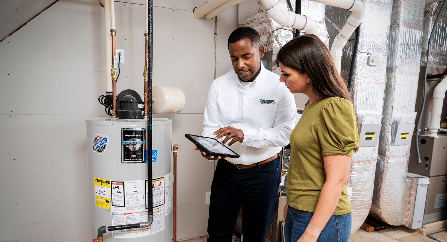 Tech reviewing water heater with client