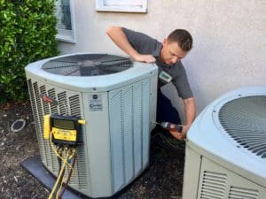 A HARP Home Services doing hvac unit maintenance