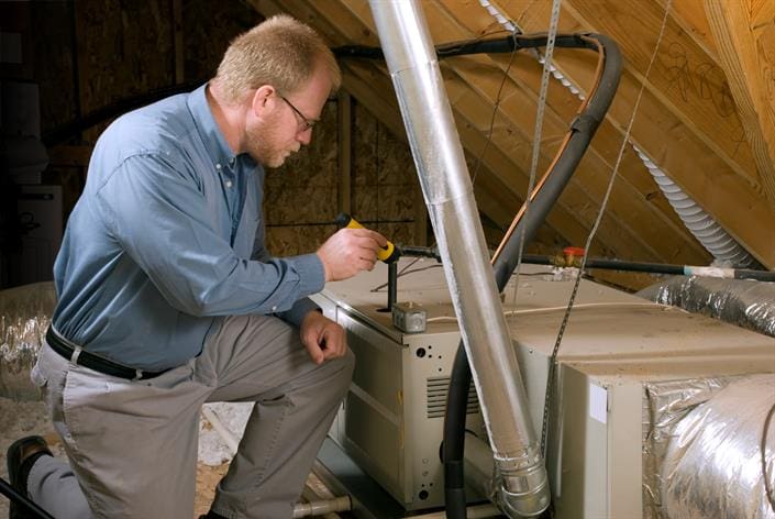 HVAC technician fixing a HVAC unit
